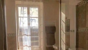 A bathroom with a shower, a toilet, and a sink.
