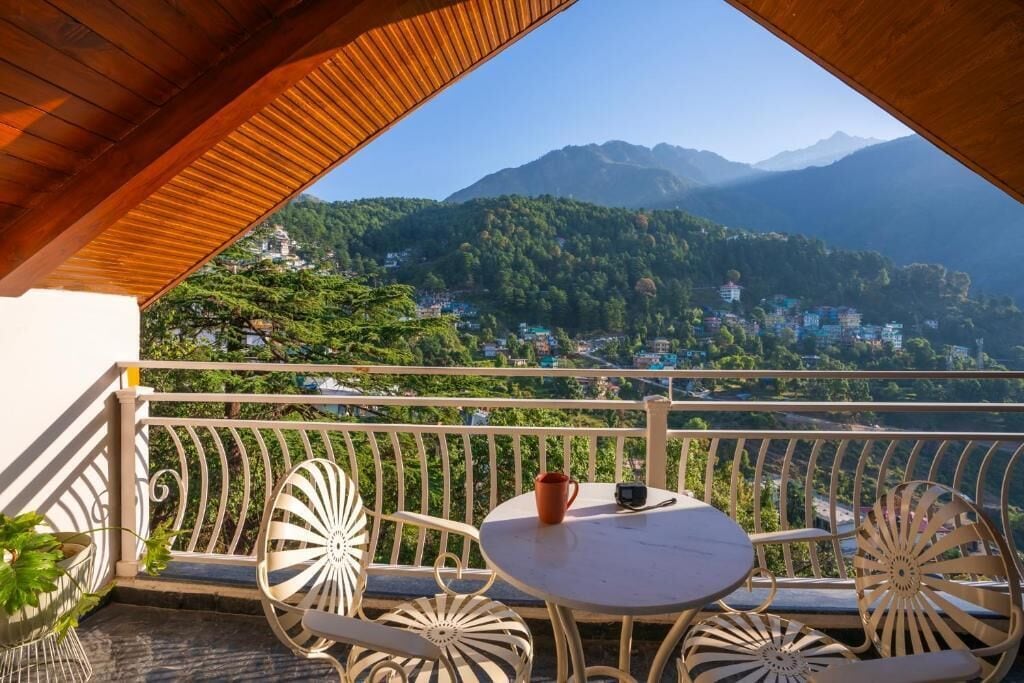 A balcony with a view of a mountainous landscape.
