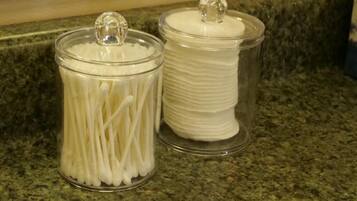 Two glass jars with lids on a granite countertop.