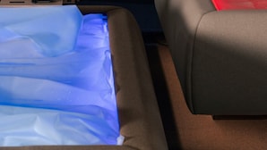 Una habitación con cama, mesita de noche y velador.