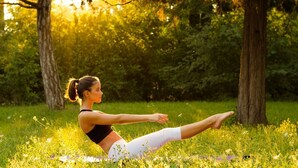 A person performing a stretching exercise outdoors on a mat. - Tenuta San Giovanni Grapefruit (Lucca)