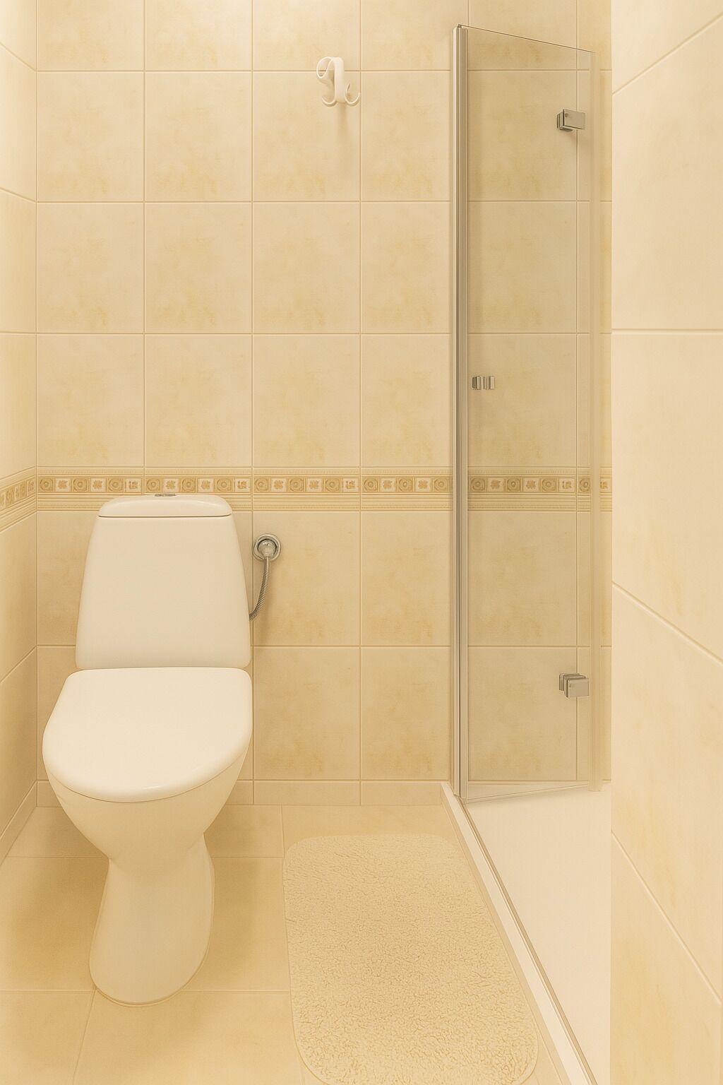 A bathroom with a toilet, a shower, and a tiled floor.