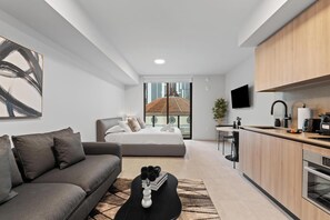 A modern apartment with a living area, a bedroom with a view, a kitchen, and a dining area. - Modern Studio Near FIFA Fan Fest | Free Parking (Miami)