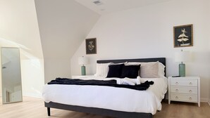 A modern bedroom with a bed, nightstands, and artwork on the walls. - Shoreham Luxe - Vibrant 4BR\2.5BA with Waterfront (Evansville)