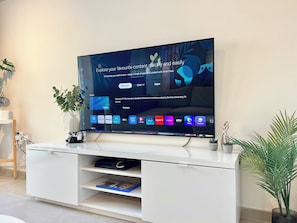 A flat-screen TV mounted on a white entertainment unit with a Samsung TV Plus interface. - Monte Napa Moments (Ayia Napa)