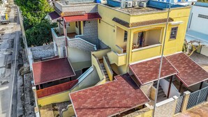 A multi-story residential building with a red-tiled roof, multiple balconies, and a visible staircase. - Favoloso Salento - Flat With Balcony 50m to Beach (Maruggio)