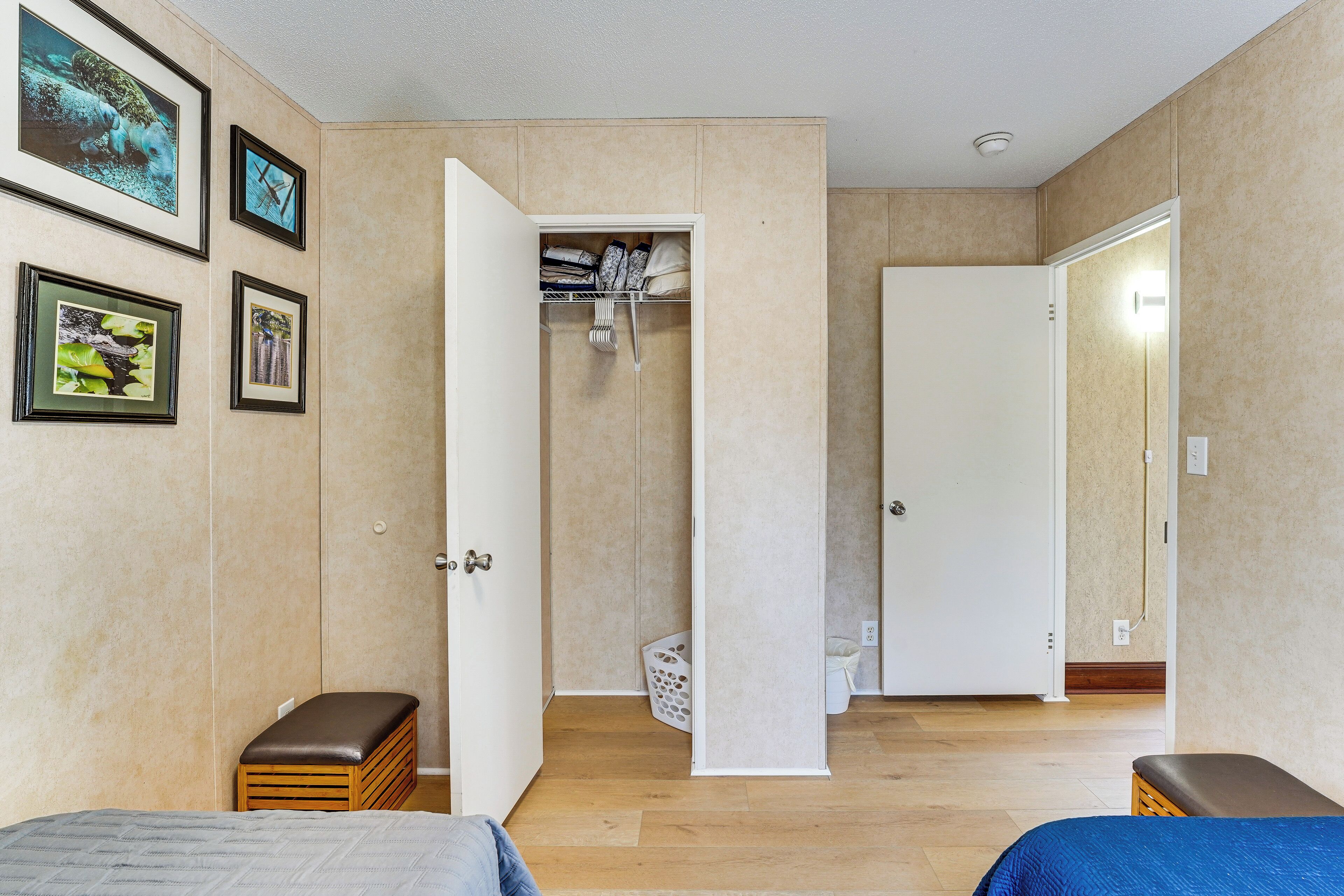 A bedroom with two beds, a closet, and a bathroom.