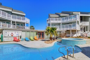 A hotel with a swimming pool, multiple balconies, and outdoor seating areas. - Walk to Beach! Pet-friendly Mustang Island Retreat (Port Aransas)