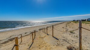 A beach with a wooden fence and a clear sky. - Walk to Broadkill Beach: Sleek Family Home w/ Deck (Milton)