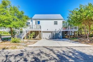 A two-story house with a garage, a front porch, and a small deck. - Walk to Broadkill Beach: Sleek Family Home w/ Deck (Milton)