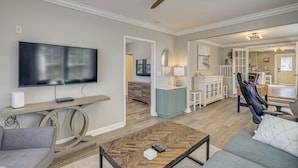 A spacious living room with a large flat-screen TV, a ceiling fan, and a comfortable seating area. - Walk to Broadkill Beach: Sleek Family Home w/ Deck (Milton)