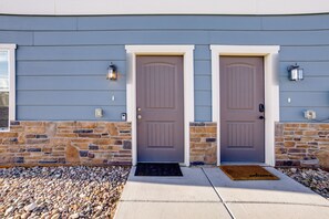A house with two front doors, a stone foundation, and a concrete walkway leading to the entrance. - Colorado Springs Family Home ~ 10 Mi to Downtown! (Colorado Springs)