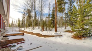 A snow-covered outdoor area with steps leading to a building, surrounded by trees. - Walk to Main St! Ultimate Winter Park Getaway (Winter Park)