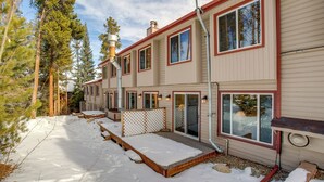 A multi-story building with a snow-covered deck and a wooden fence. - Walk to Main St! Ultimate Winter Park Getaway (Winter Park)