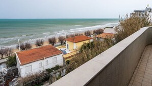 A coastal view with buildings, a beach, and a sea. - San Menaio Apartment by Rentbeat (Vico del Gargano)