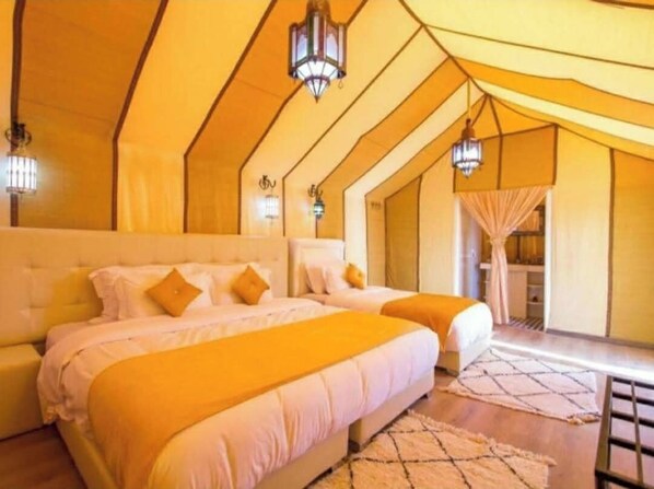 A bedroom with two beds, a large window, and a view of the outside. - Merzouga Luxury Tented (Merzouga)