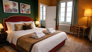 A hotel room with a large bed, two bedside lamps, a radiator, a wooden chair, and two framed artworks on the wall. - Le Château de Chambois ✦ Confidential ✦ Families ✦ Seminars (Gouffern en Auge)