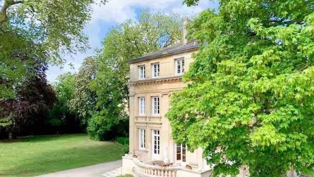 A two-story building with a symmetrical facade, a central entrance with steps, and a well-maintained garden with a gravel path leading to the entrance. - Le Château de Chambois ✦ Confidential ✦ Families ✦ Seminars (Gouffern en Auge)