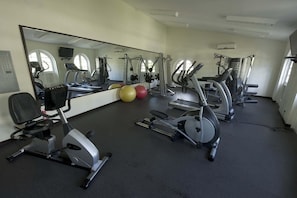 A gym with stationary bikes, treadmills, and exercise balls. - Sapphire Beach 201 3 Bedroom Apts (St. Lawrence Gap)