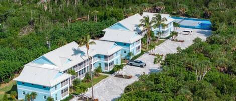 A resort with multiple buildings, a parking area, and surrounding greenery.