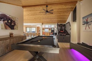 A pool table with a ceiling fan, wooden ceiling, and a ski-themed painting. - Powder and Pines on Knight, walk to the village (Big Bear Lake)