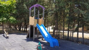 A playground with a slide and climbing structures. - Bungalow with Terrace - Sleeps 2 (Humilladero)