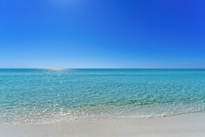 A beach with clear turquoise water and a bright blue sky. - Book 3 Nights, Get 1 Free (See Description) | Right On Beach, Golf Cart, Hot Tub (Miramar Beach)