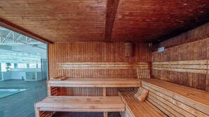 A sauna with wooden benches and a bench seat, large windows, and a tiled floor. - Mobile Home with Terrace in Crevillent (Crevillente)