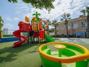 A playground with a slide, climbing structures, and a small pool. - Bungalow with Terrace and Accessible Ramp in Guardamar (Guardamar del Segura)