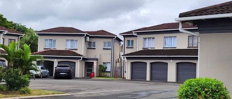 A residential area with multiple two-story houses, each with a garage.