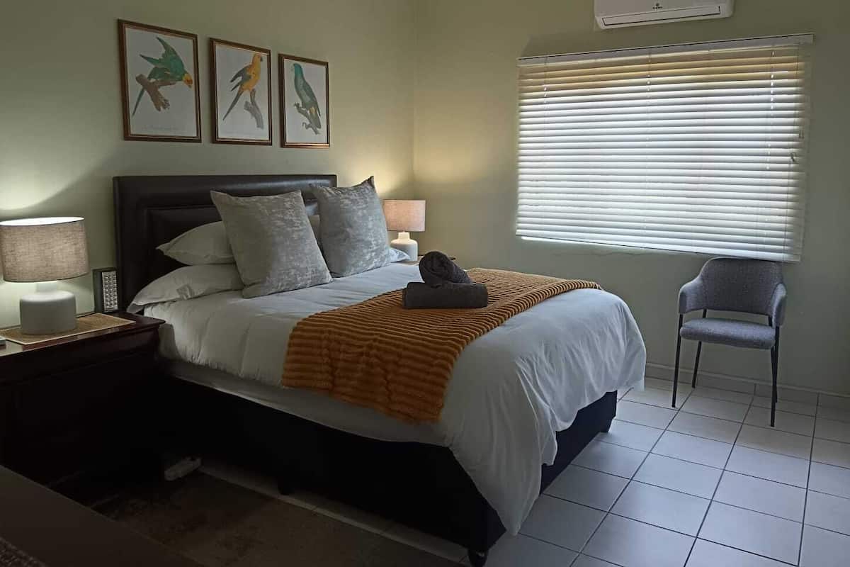 Deluxe Apartment, Patio, Garden View | Desk, laptop workspace, blackout curtains, iron/ironing board