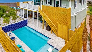 A beachfront property with a pool, a covered patio, and a two-story house. - Beachfront House - Casa Bella Del Sol (Port St. Joe)