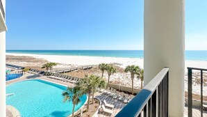 A pool area with lounge chairs and a view of the beach. - 3rd Floor!! Parking Level!  Avoid the Elevators!! Lazy River!! (Orange Beach)