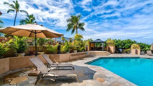 A pool area with lounge chairs, a gazebo, and potted plants. - Kona Pacific E734: Penthouse Corner unit, Best Ocean Views, AC, Walk to town (Kailua Kona)