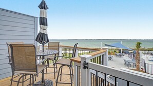 A deck with outdoor furniture, a view of the water, and a railing. - Beautiful, Pet Friendly, Waterfront Townhome at San De Luna #3! (Pensacola Beach)