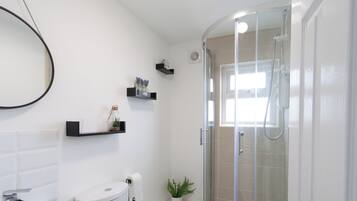 Shower, hair dryer, towels, toilet paper