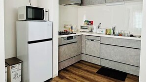 Cocina compacta equipada con microondas, estufa y lavavajillas.