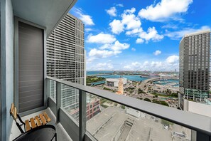 A balcony with a view of a marina and buildings. - 501 Building - Condo Miami - We Host (Miami)