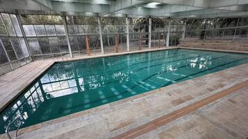 Indoor pool, open 7:00 AM to 9:00 PM, pool loungers, lifeguards on site