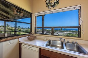 A kitchen with a large window, a dishwasher, and a sink. - Wailea Ekolu 408 Spacious Second-Floor Retreat with Panoramic Ocean Views (Kihei)