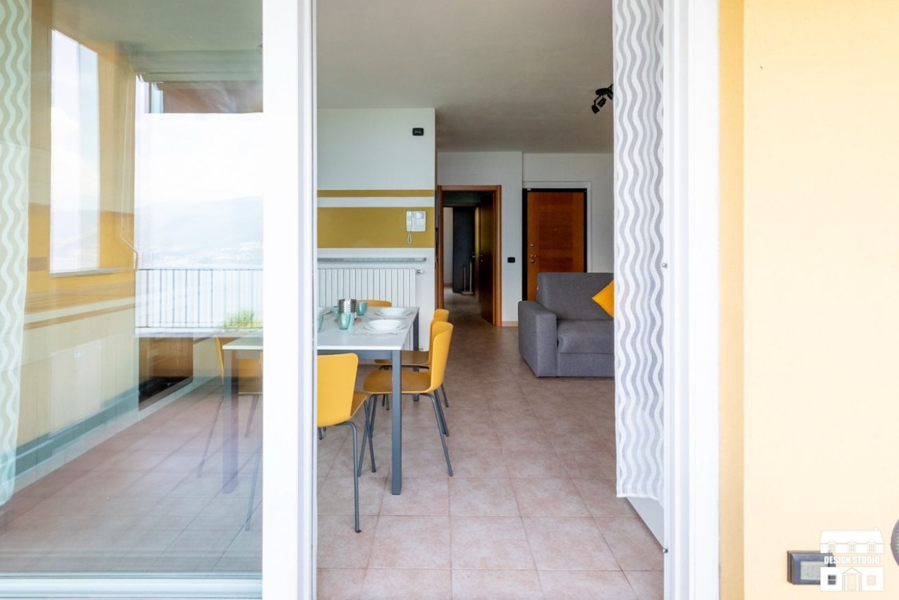 A dining area with a table and chairs, a sofa, and a radiator.