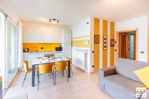 A modern kitchen with white cabinets, a yellow countertop, and a dining area with a table and chairs. - MOLTO IMPORTANTE: Questa casa è molto facile da trovare, ma le mappe non mostrano l'indirizzo effettivo.Per favore, usa SOLO la mappa che ti fornirò, insieme alle istruzioni per il check-in.Una vista mozzafiato in un luogo incantevole: 1 grande apparta (Bellano)
