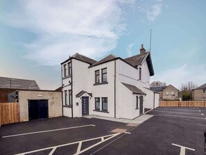 A two-story residential building with a garage, a driveway, and a parking area. - William Wallace View - 5 Bedroom House Near Castle (Stirling)