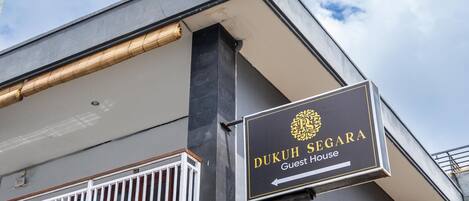 A building with a sign reading "Dukuh Segara Guest House".