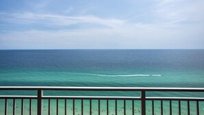 A view of the ocean from a balcony with a railing, clear sky, and calm sea. - ☀️Gulf FRONT-Pools+Hot Tubs-Emerald Beach 2030☀️ (Panama City Beach)
