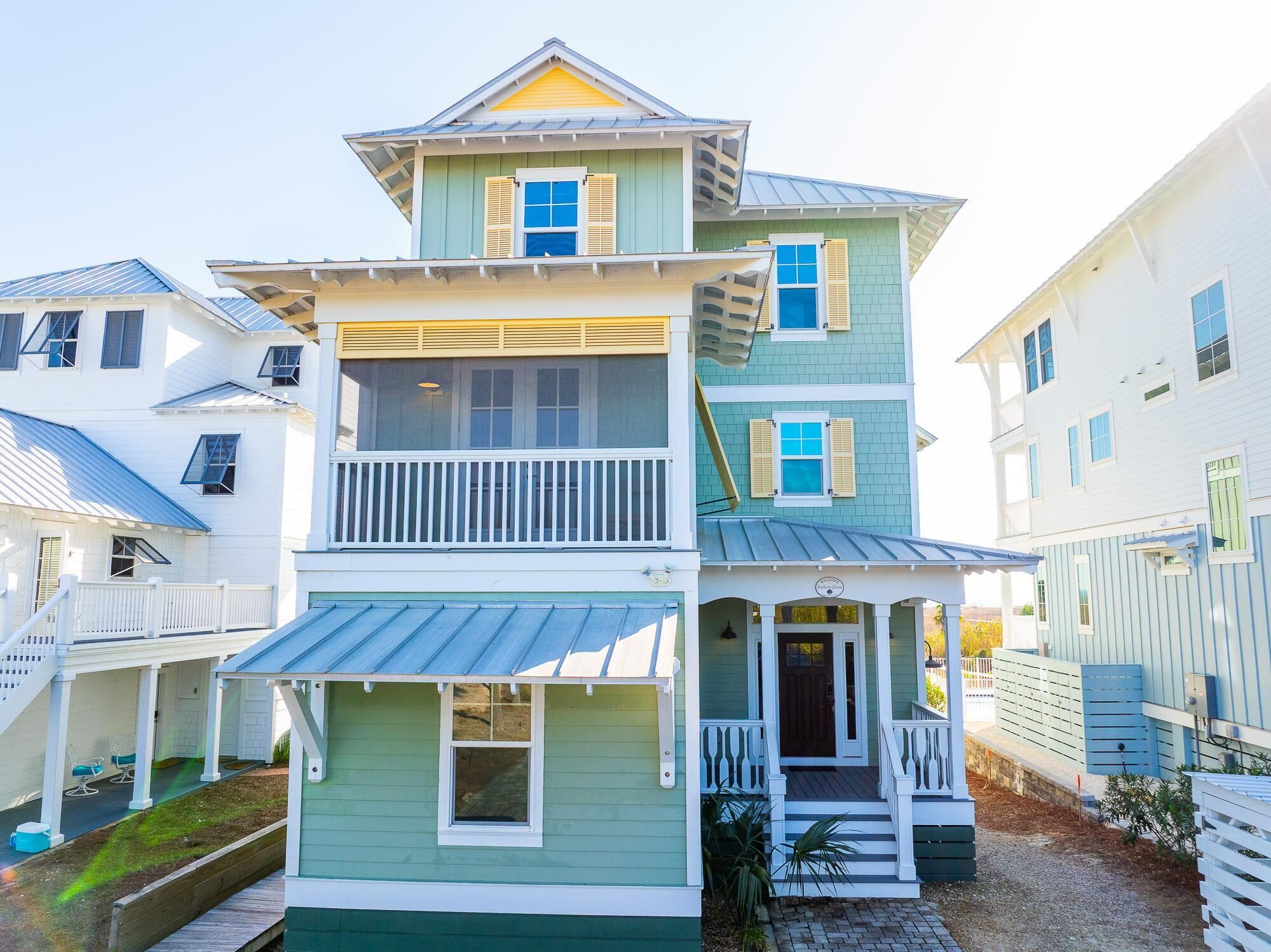 A two-story house with a balcony, a porch, and a small front yard.