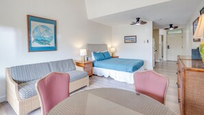 A bedroom with a bed, bedside tables, a sofa, and a dining table. - Kihei Bay Surf B212: Beachside Studio w/ Pool & Lanai (Kihei)