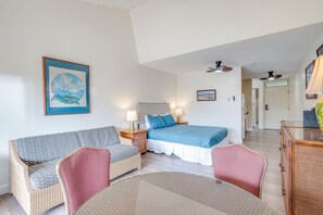 A bedroom with a bed, bedside tables, a sofa, and a dining table. - Kihei Bay Surf B212: Beachside Studio w/ Pool & Lanai (Kihei)