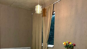 A compact bedroom with a bed, a desk, and a chair. - Holiday Garden Tbilisi (Tbilisi)