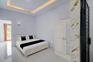 A bedroom with a bed, wardrobe, and a door with a handle. - Hotel O near Mangusada Hospital formerly (Mengwi)